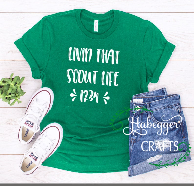 May include: Green t-shirt with white text that reads "Livin that Scout Life *1234*"