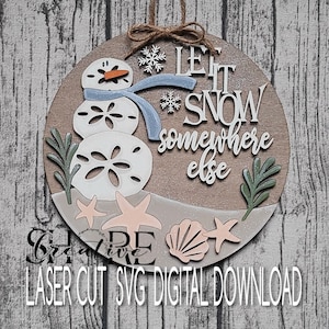 May include: A round wooden sign with a snowman made of sand dollars and the text "Let it snow somewhere else".