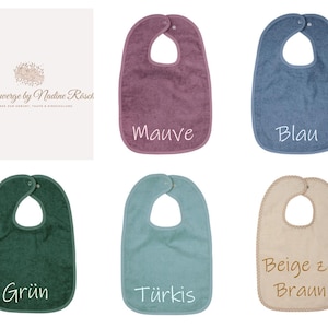 May include: A collection of baby bibs in various colors, including mauve, blue, green, turquoise, and beige. Each bib has a rounded shape with a neck opening and a snap closure. The bibs are labeled with their respective color names.