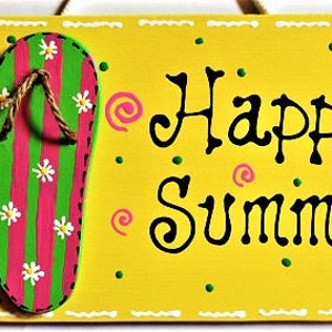 May include: A yellow wooden sign with the words "Happy Summer" in black script. The sign features two flip-flops with green and pink stripes, white flower accents, and brown rope straps. Decorative dots and swirls complete the design.