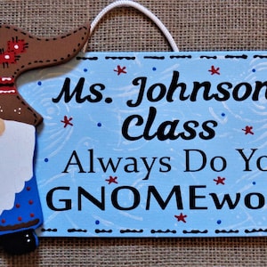 May include: A blue wooden sign with a gnome illustration and the text "Ms. Johnson's class Always Do Your GNOMEwork!"