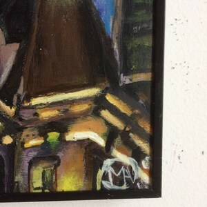 May include: A framed painting of a city scene with buildings in shades of brown, yellow, and green. The painting is signed "MAV" in the lower right corner.