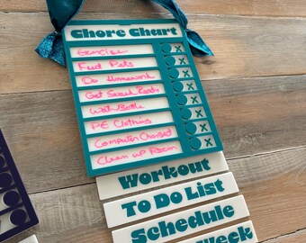 May include: A teal blue chore chart with a white background and pink writing. The chart has a hanging loop and includes a list of chores with check boxes. Below the chart are four white labels with teal blue text: Workout, To Do List, Schedule, and Days of the Week.