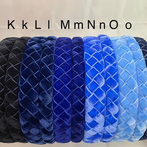 May include: Eight velvet headbands in various shades of blue, from dark navy to light blue, with a quilted pattern. The headbands are arranged in a row, with the darkest shade on the left and the lightest shade on the right. The text "KKLIMmNnOo" is written above the headbands.