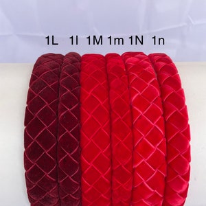 May include: Six velvet headbands in different shades of red, from burgundy to bright red. The headbands are all the same style, with a woven diamond pattern. The headbands are labeled 1L, 1I, 1M, 1m, 1N, and 1n.