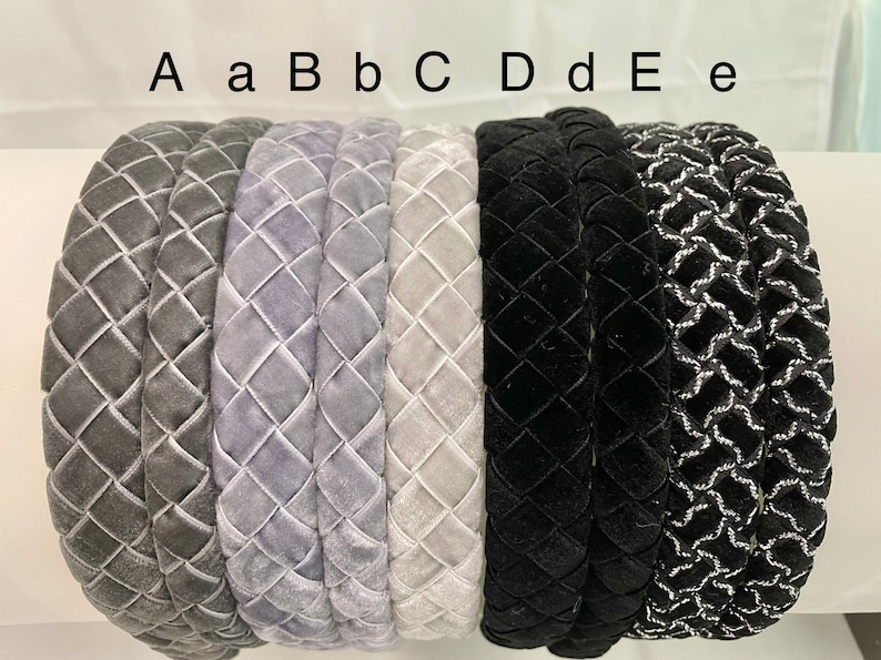 May include: A set of eight headbands in various colors and patterns. The headbands are made of velvet and have a quilted design. The headbands are labeled A, a, B, b, C, D, d, E, and e.