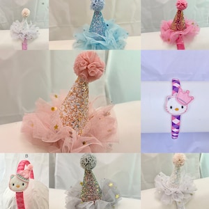 May include: A set of ten party hats for girls, each with a different color tulle and glitter design. The hats are decorated with gold stars and come with a matching headband.