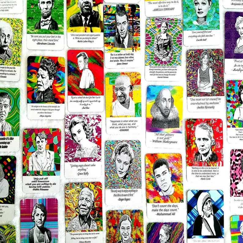 May include: A collection of colorful cards featuring portraits of famous figures like Abraham Lincoln, Amelia Earhart, and Muhammad Ali. Each card includes a quote attributed to the person depicted. The cards have a vibrant, artistic style.
