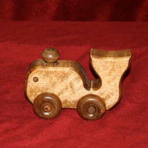 Wooden Willie Whale push toy has a moving spout! Excellent child&#39;s toy. 7&quot; long, 3 1/4&quot; wide, and 4 1/2&quot; tall. Made from birch wood.