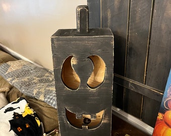 Handmade wooden jack o lantern box available in orange, black, or white