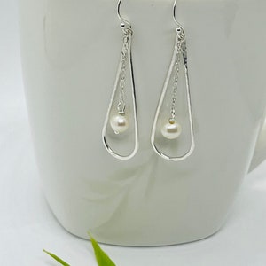 Hammered sterling silver narrow teardrop hoop with pearl drop earring