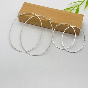 Oval hammered sterling silver hoop earring