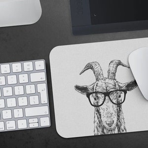 May include: A black and white illustration of a goat wearing glasses. The goat is drawn in a realistic style with detailed features. The background is a light grey.