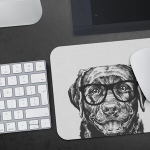 May include: Black and white illustration of a Labrador Retriever wearing glasses. The dog is looking directly at the viewer with a friendly expression. The illustration is on a white background.