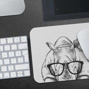 May include: A black and white illustration of a rhinoceros wearing glasses. The rhinoceros is drawn in a cartoon style and has a friendly expression. The background is a light grey.
