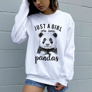 May include: White sweatshirt with a black and white panda illustration and the text "Just a girl who loves pandas".