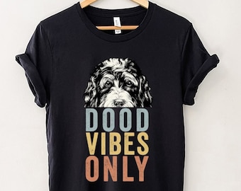 May include: Black t-shirt with a graphic of a doodle dog and the text "DOOD VIBES ONLY" in a vintage style font.