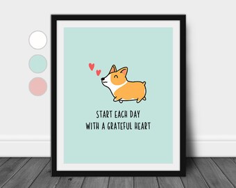 May include: A printable art print featuring a cartoon corgi dog with a light blue background. The corgi is blowing three red hearts and the text "Start each day with a grateful heart" is below the dog.
