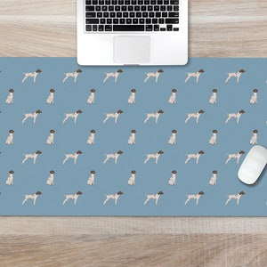 May include: A blue desk mat with a repeating pattern of white and brown German Shorthaired Pointer dogs. A white computer mouse is on the mat.