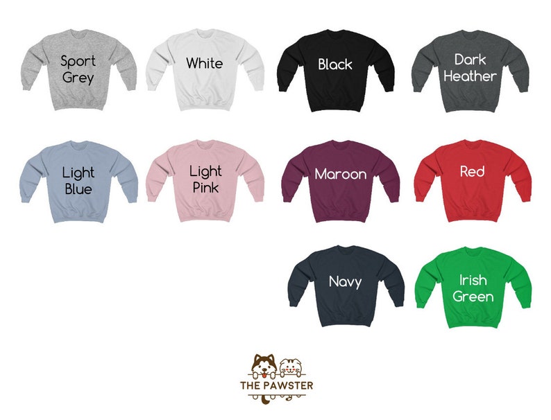 May include: A set of ten crewneck sweatshirts in various colors, including sport grey, white, black, dark heather, light blue, light pink, maroon, red, navy, and Irish green. Each sweatshirt has a different color text label on the front, indicating the color of the sweatshirt.