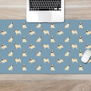 May include: A blue desk mat with a repeating pattern of pugs. A white computer mouse is on the mat.