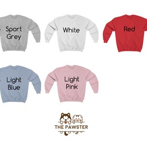 May include: Five different color crew neck sweatshirts with the text "Sport Grey", "White", "Red", "Light Blue", and "Light Pink" printed on the front. The sweatshirts are all the same style and have a small logo of a dog with the text "THE PAWSTER" below it.