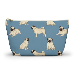 May include: A blue zippered pouch with a repeating pattern of white pugs. The pugs are in various poses, including sitting, standing, and lying down.