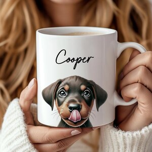 May include: White ceramic coffee mug with a brown and black puppy dog illustration and the name "Cooper" printed in black cursive.