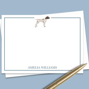 May include: White stationery with a blue border and a black and white illustration of a dog. The text "AMELIA WILLIAMS" is printed at the bottom.