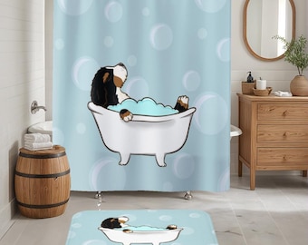 May include: A blue shower curtain with a cartoon dog in a bathtub with bubbles. The dog is brown and white with black ears. The shower curtain has a white bath mat with a similar cartoon dog on it.