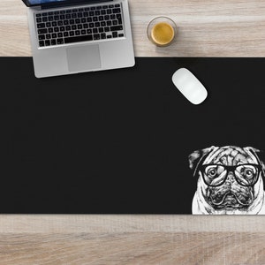 May include: Black desk mat with a white pug wearing glasses peeking out from the bottom right corner.