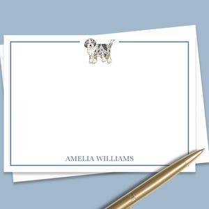 May include: White stationery with a blue border and a small illustration of a dog. The name "AMELIA WILLIAMS" is printed at the bottom.