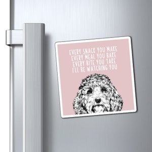 May include: A pink refrigerator magnet with a black and white illustration of a dog. The text on the magnet reads "Every snack you make, every meal you bake, every bite you take, I'll be watching you."