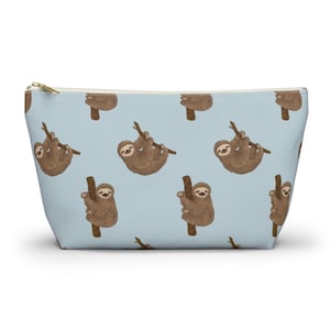 May include: A light blue zippered pouch with a repeating pattern of brown sloths hanging from branches.