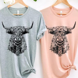 Funny and Cute Nerdy Highland Cow Wearing Glasses shirt for Animal lovers! This Scottish Highland Cow art tshirt, tank top, kids tee, youth or sweatshirt is a perfect gift for Highland Cattle Lover, and Farm Animal Lovers.