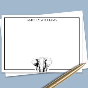 May include: A white card with a black border and the text "AMELIA WILLIAMS" at the top. A black and white illustration of an elephant's head is at the bottom of the card.