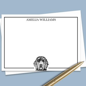 May include: White stationery with a black border and the name "AMELIA WILLIAMS" printed at the top. A black and white illustration of a dog's head is at the bottom of the card.
