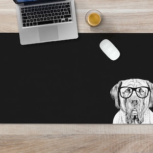 May include: Black desk mat with a white illustration of a dog wearing glasses. The dog is looking directly at the viewer.