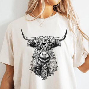 Funny and Cute Nerdy Highland Cow Wearing Glasses shirt for Animal lovers! This Scottish Highland Cow art tshirt, tank top, kids tee, youth or sweatshirt is a perfect gift for Highland Cattle Lover, and Farm Animal Lovers.
