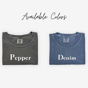 May include: Two folded t-shirts, one gray with the word "Pepper" and one blue with the word "Denim" printed on them. Available Colors.