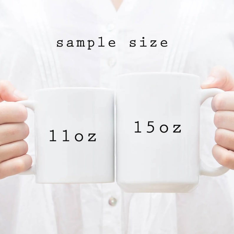 May include: Two white ceramic mugs with black text. The mug on the left says "11 oz" and the mug on the right says "15 oz".