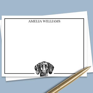 May include: White stationery with a black border and the name "Amelia Williams" printed at the top. A black and white illustration of a dog's head is at the bottom of the stationery.