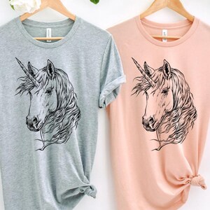 Funny and Cute Nerdy Unicorn Wearing Glasses shirt for Unicorn lovers! This Unicorn art tshirt, tank top, kids tee, youth or sweatshirt is a perfect gift for Unicorn Lover and Animal Lovers.