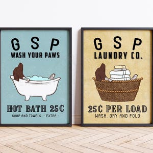 May include: Two vintage-style signs with a dog illustration. The first sign is blue and says "GSP Wash Your Paws Hot Bath 25c Soap and Towels - Extra". The second sign is yellow and says "GSP Laundry Co. 25c Per Load Wash. Dry and Fold".