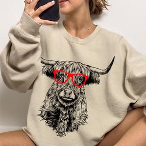 Funny and Cute Nerdy Highland Cow Wearing Glasses shirt for Animal lovers! This Scottish Highland Cow art tshirt, tank top, kids tee, youth or sweatshirt is a perfect gift for Highland Cattle Lover, and Farm Animal Lovers.