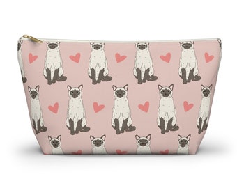 May include: A pink zippered pouch with a repeating pattern of white Siamese cats and pink hearts.