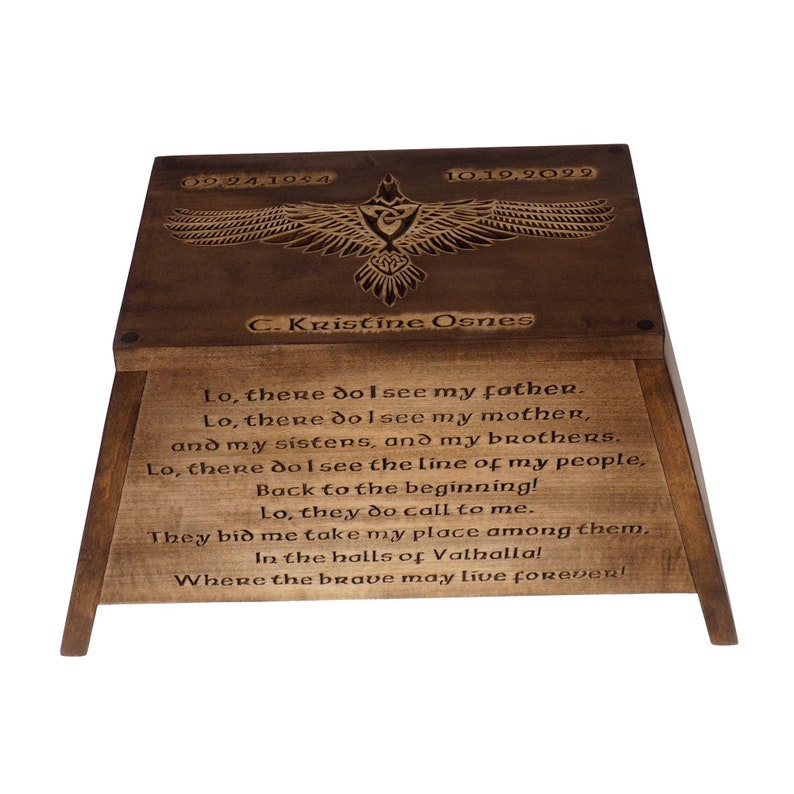 May include: A wooden box with a carved eagle design and the text "Lo, there do I see my father. Lo, there do I see my mother, and my sisters, and my brothers. Lo, there do I see the line of my people, Back to the beginning! Lo, they do call to me. They bid me take my place among them, In the halls of Valhalla! Where the brave may live forever!"