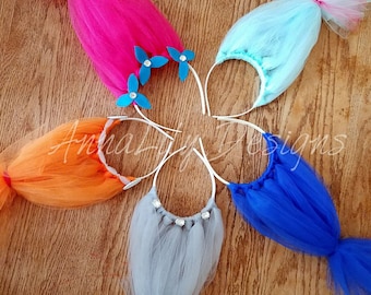 May include: Five colorful tulle hair bows with white headbands. The bows are pink, orange, light blue, blue, and gray. The pink bow has blue flower embellishments.