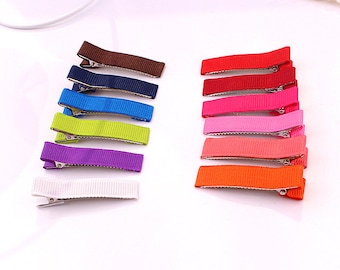 May include: A set of 12 hair clips with different colored ribbon. The colors include white, purple, green, blue, navy, brown, orange, red, pink, light pink, and dark red.