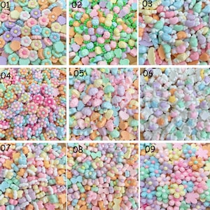 Peut inclure: Neuf ensembles différents de perles en plastique de couleur pastel. Chaque ensemble présente un design différent, y compris des fleurs, des cœurs, des étoiles et d'autres formes. Les perles sont parfaites pour l'artisanat et la fabrication de bijoux.